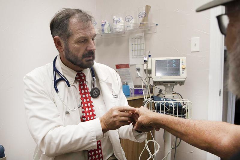 Richard Templeman checking patients hand