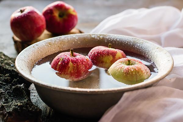 ripe apples in a bowl of water