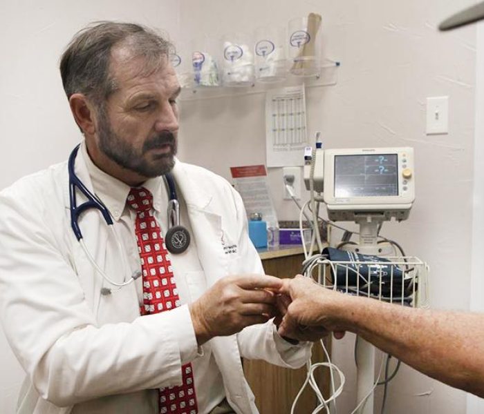 Richard Templeman checking patients hand